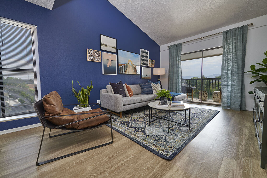 Open living room with blue accent wall and glass patio doors