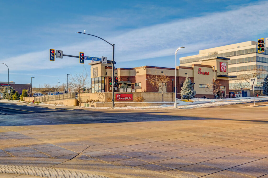 Outdoor shopping district with several storefronts, and restaurants