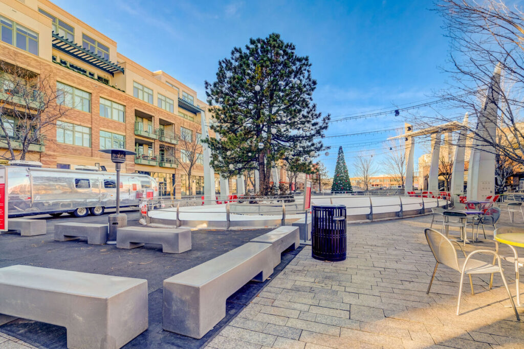 Public courtyard with patio seating and string lights