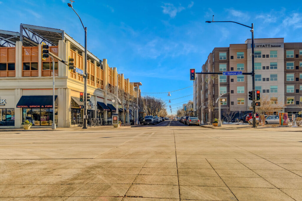 Outdoor shopping district with several storefronts, and restaurants