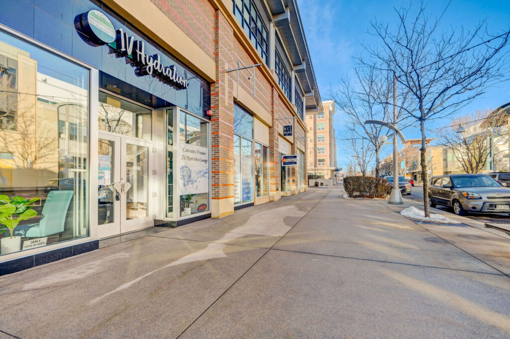 Outdoor shopping district with several storefronts, and restaurants