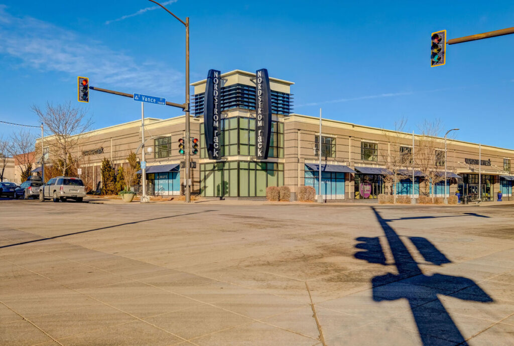 Outdoor shopping district with several storefronts, and restaurants