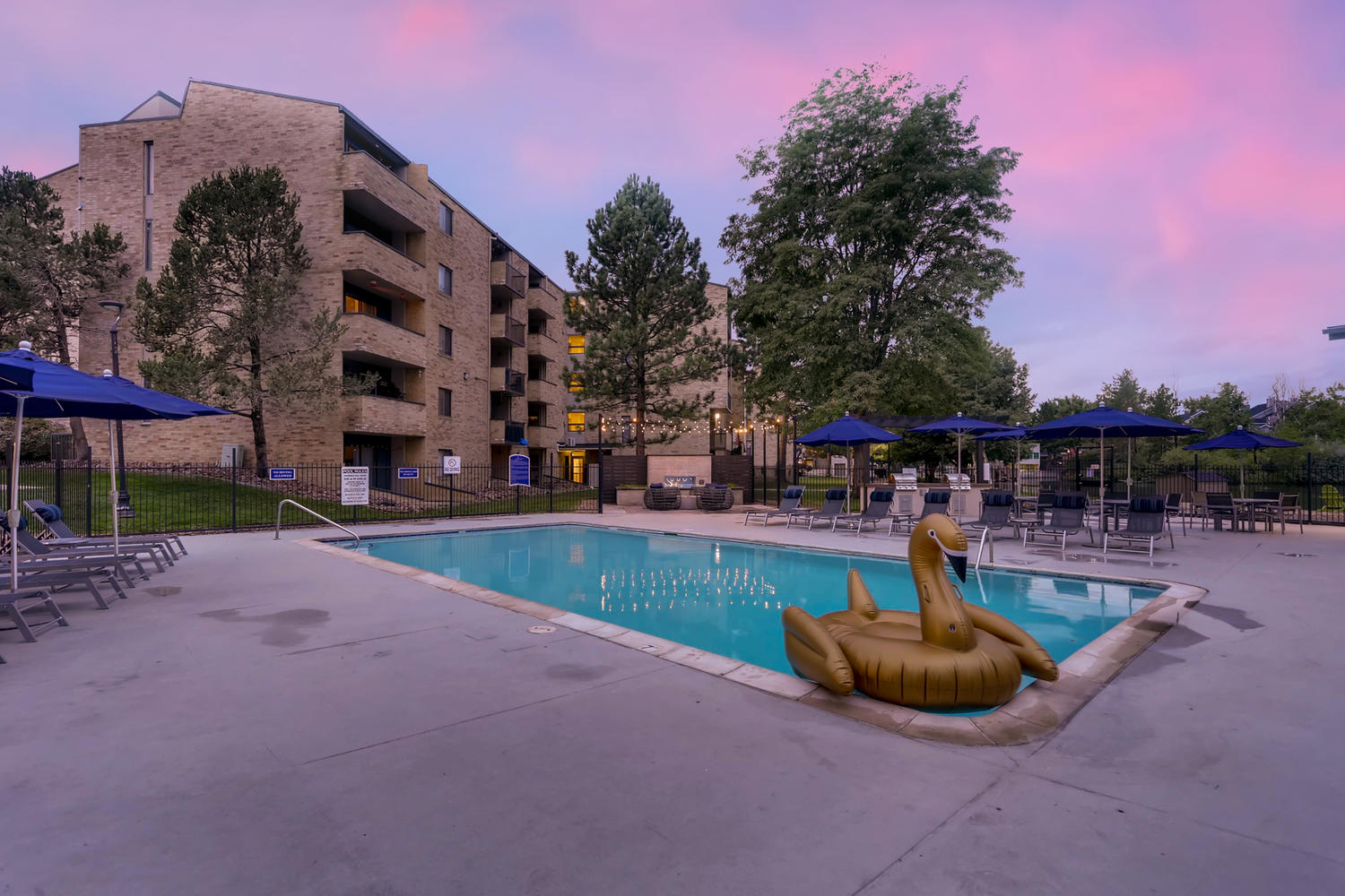 Pool with deck chairs, umbrellas, and grilling stations